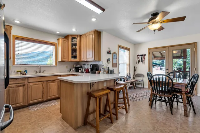a kitchen with stainless steel appliances granite countertop a sink dishwasher and cabinets with wooden floor