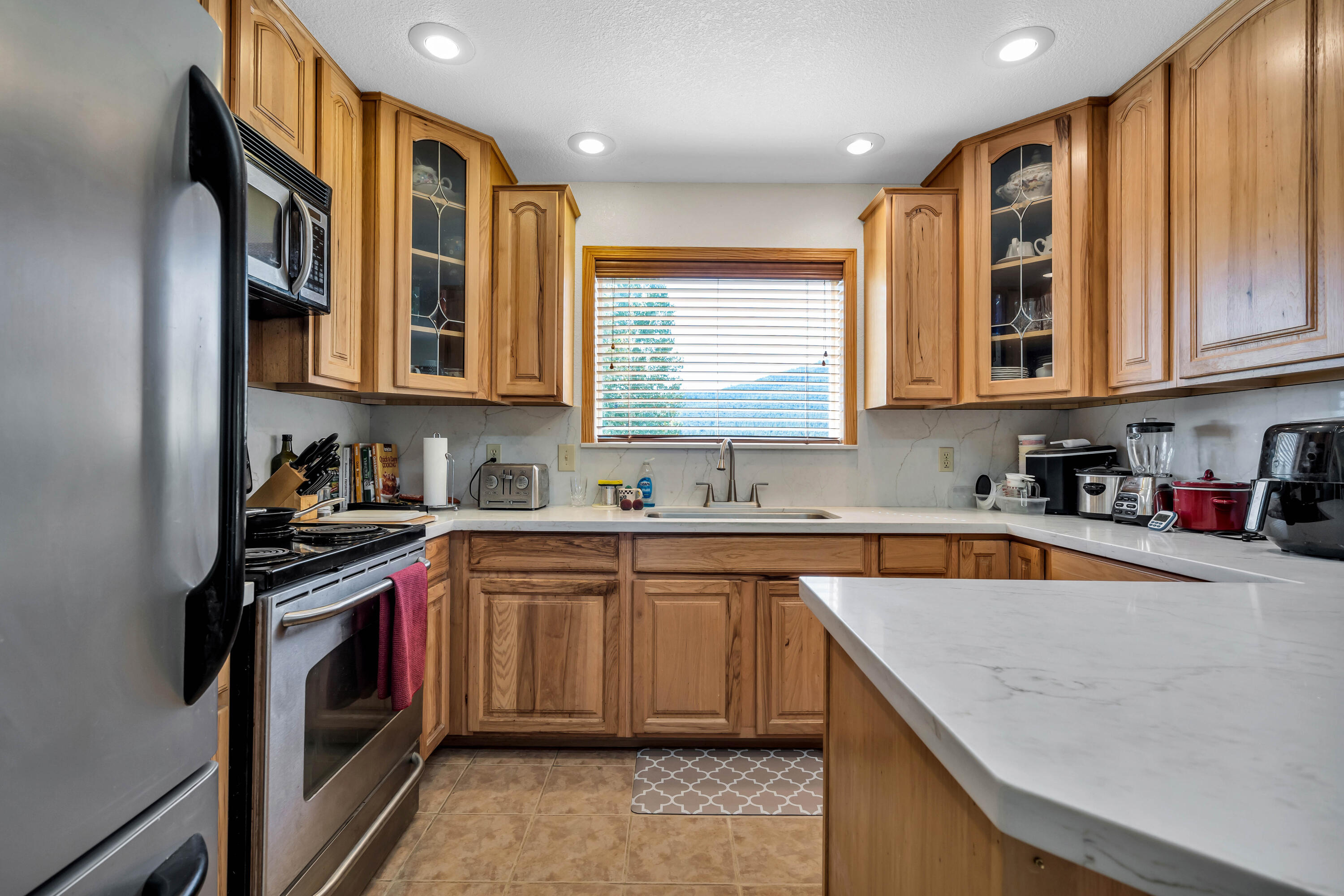 26929 Linfield Street Fall River Mills, CA 96028 - Photo 14 of 66 a kitchen that has a sink and a stove in it