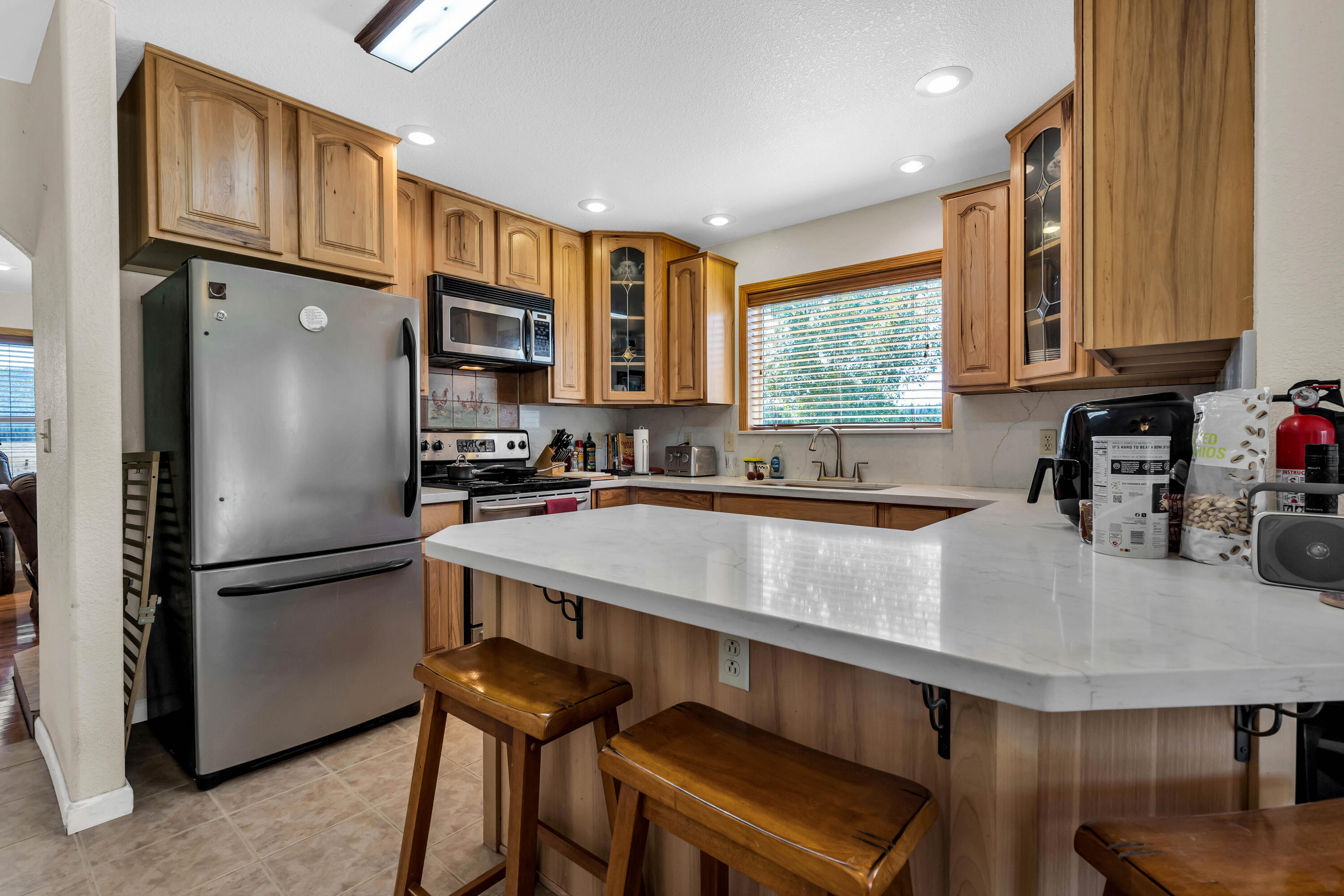 26929 Linfield Street Fall River Mills, CA 96028 - Photo 15 of 66 a kitchen with stainless steel appliances granite countertop a refrigerator a sink a stove and a microwave
