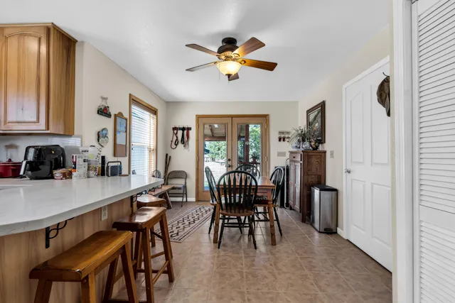 a bedroom with a bed a couch and a chandelier