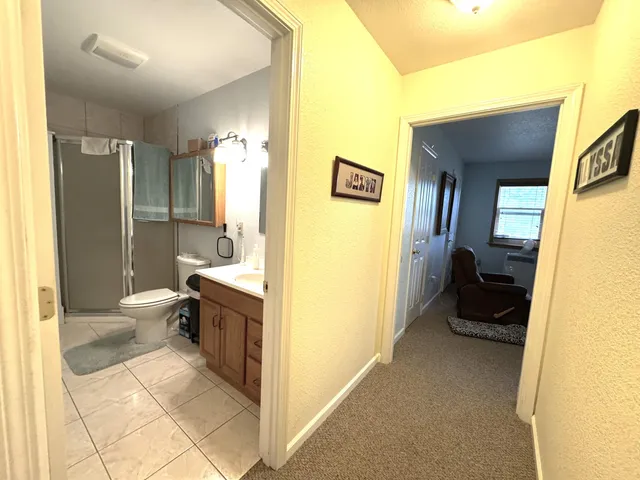a utility room with fridge and a sink