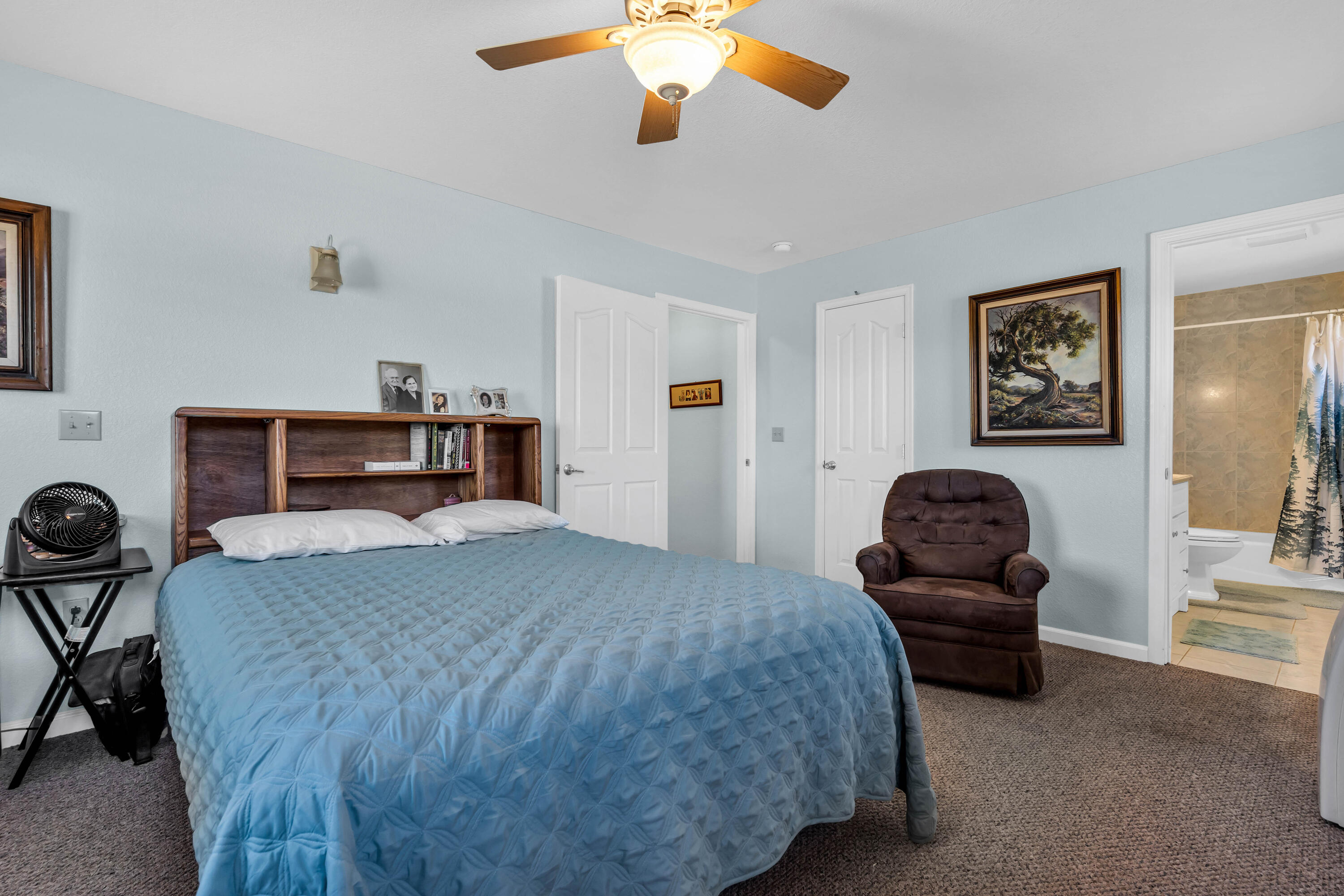 26929 Linfield Street Fall River Mills, CA 96028 - Photo 35 of 66 a bedroom with a bed and a chandelier
