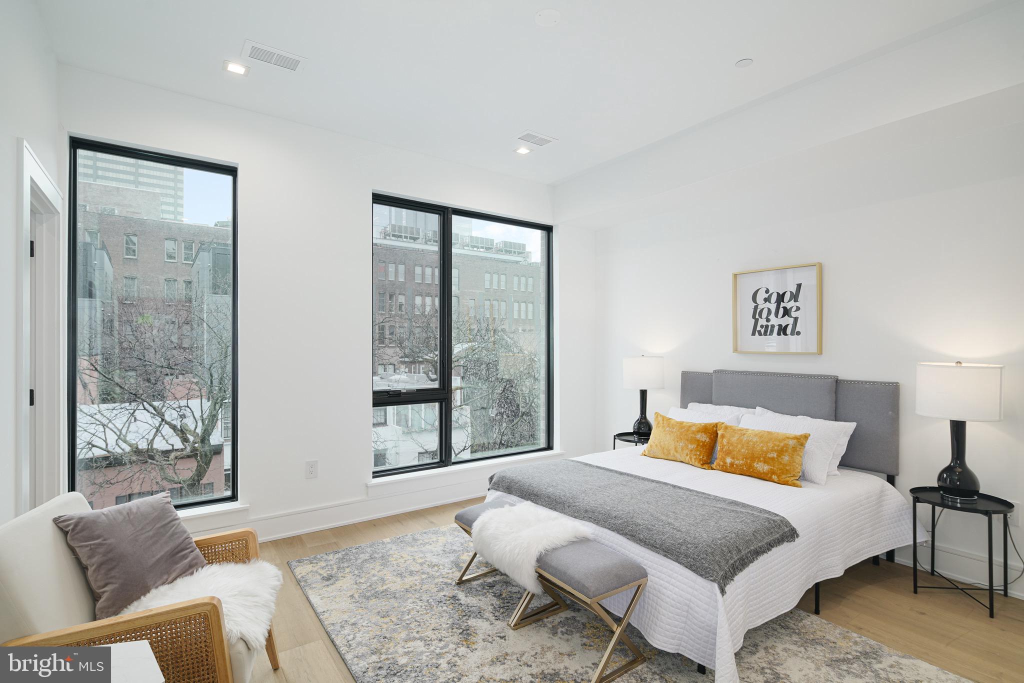 2324 Sansom Street Philadelphia, PA 19103 - Photo 37 of 82 a bedroom with a bed and glass window