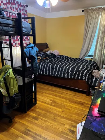 a bedroom with a bed and teddy bear on bed