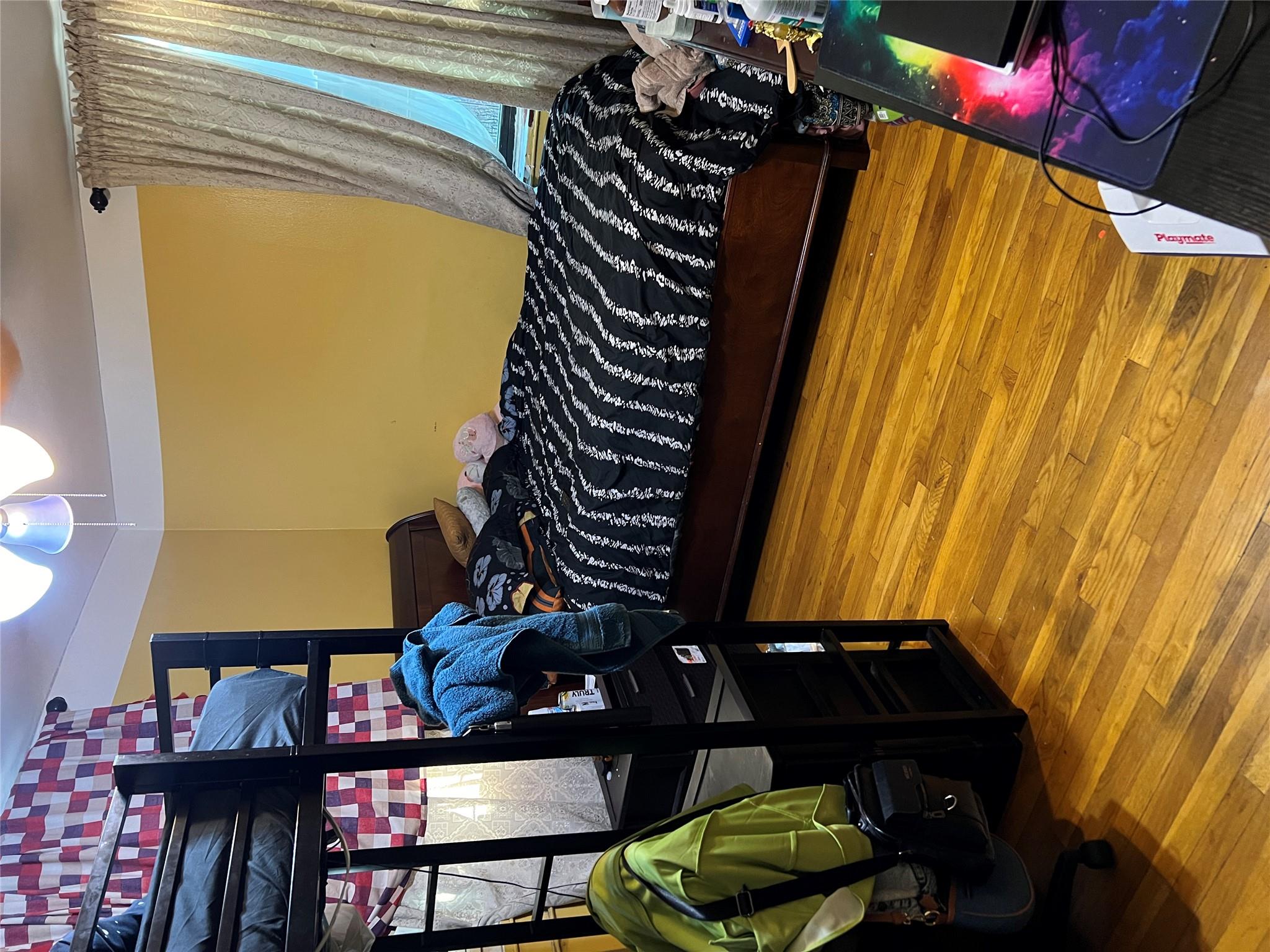 55-30 99th Street, Unit 2H Queens, NY 11368 - Photo 12 of 19 a bedroom with a bed and teddy bear on bed