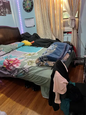 a bedroom with bed and a window