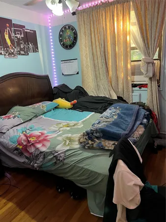 a room with a bed and flat screen tv