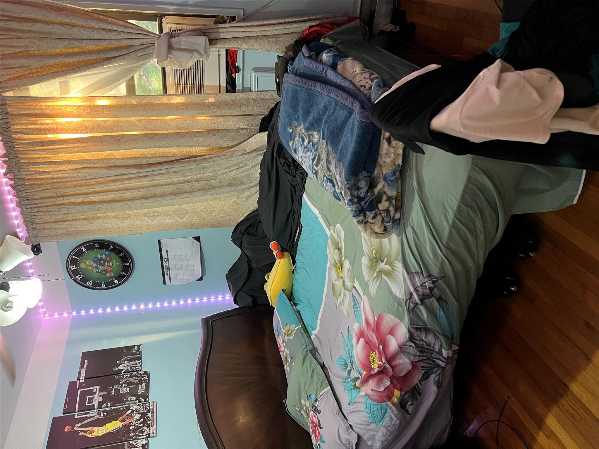 55-30 99th Street, Unit 2H Queens, NY 11368 - Photo 15 of 19 a bedroom with bed and a window