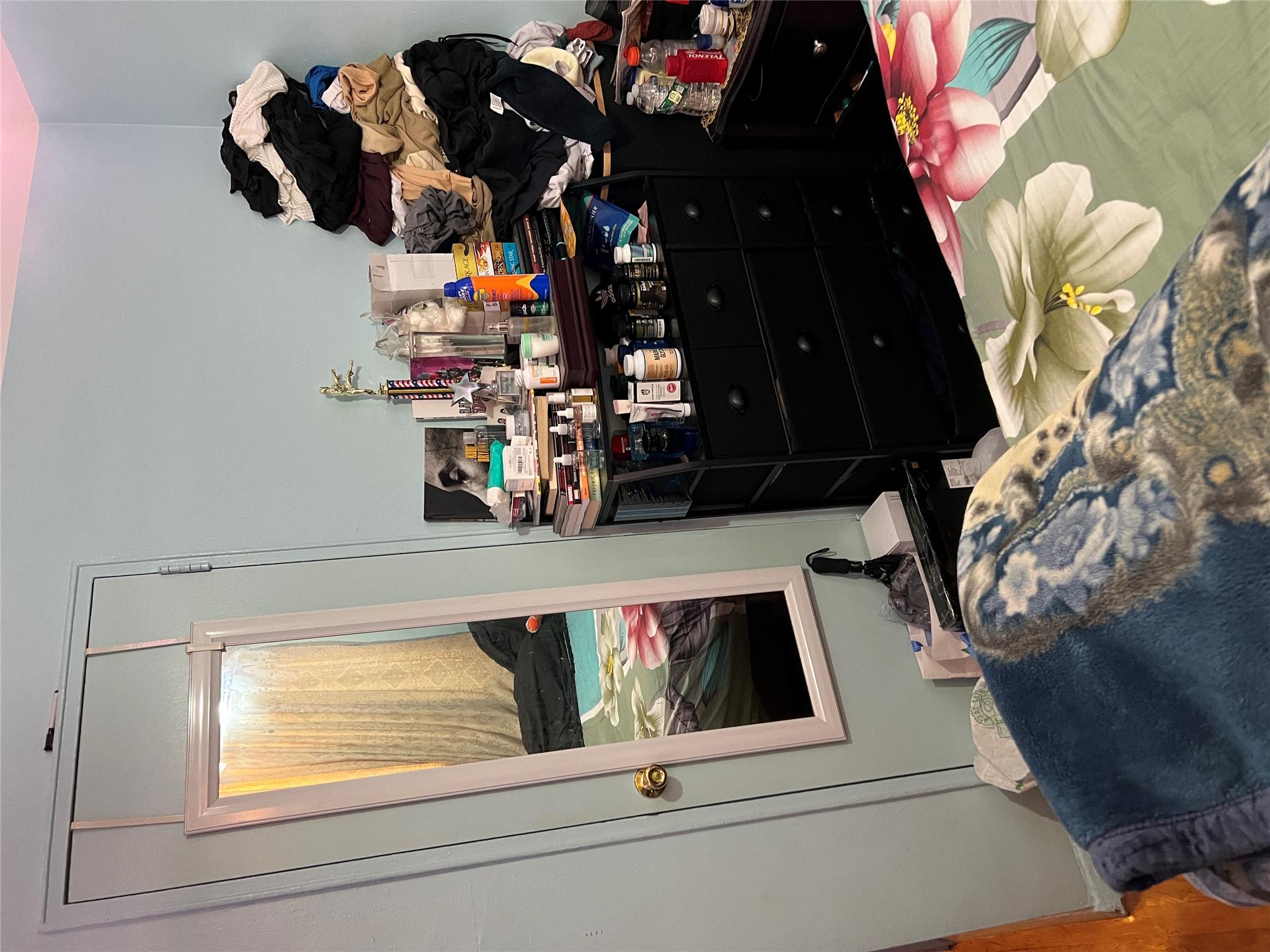 55-30 99th Street, Unit 2H Queens, NY 11368 - Photo 16 of 19 a room with a bed and flat screen tv