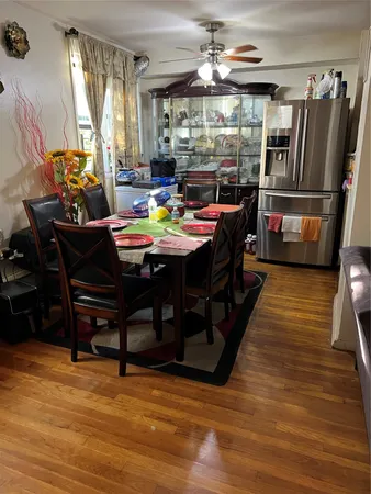 a view of a dining room with furniture window and wooden floor