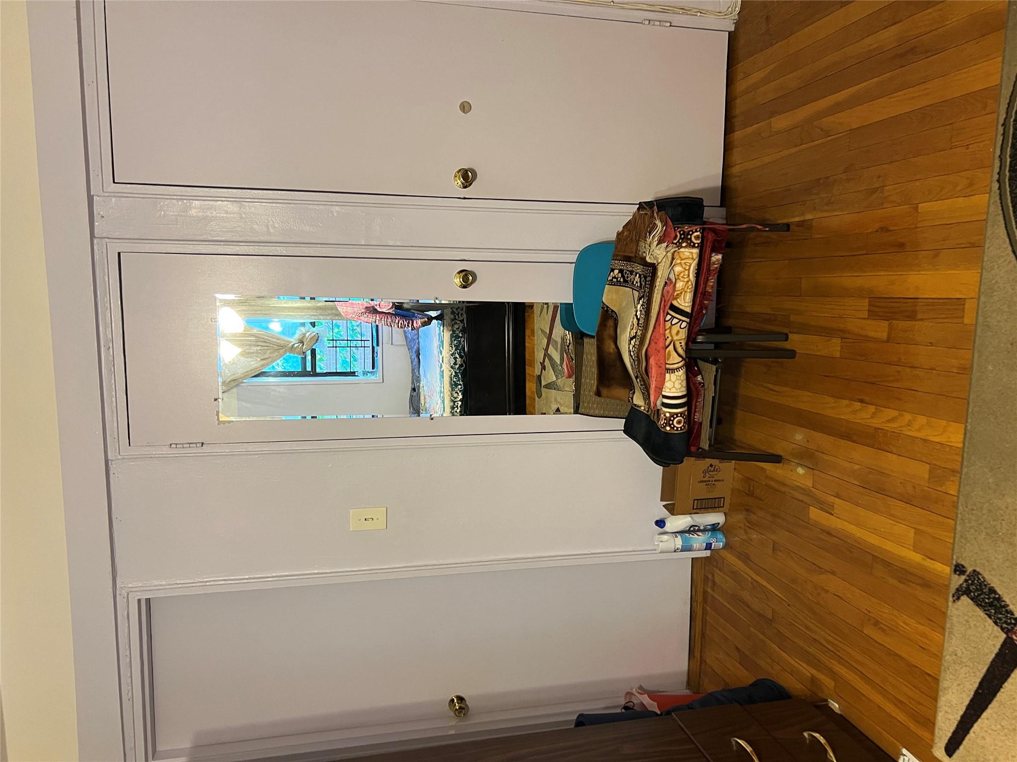 55-30 99th Street, Unit 2H Queens, NY 11368 - Photo 9 of 19 a bedroom with a bed and a table