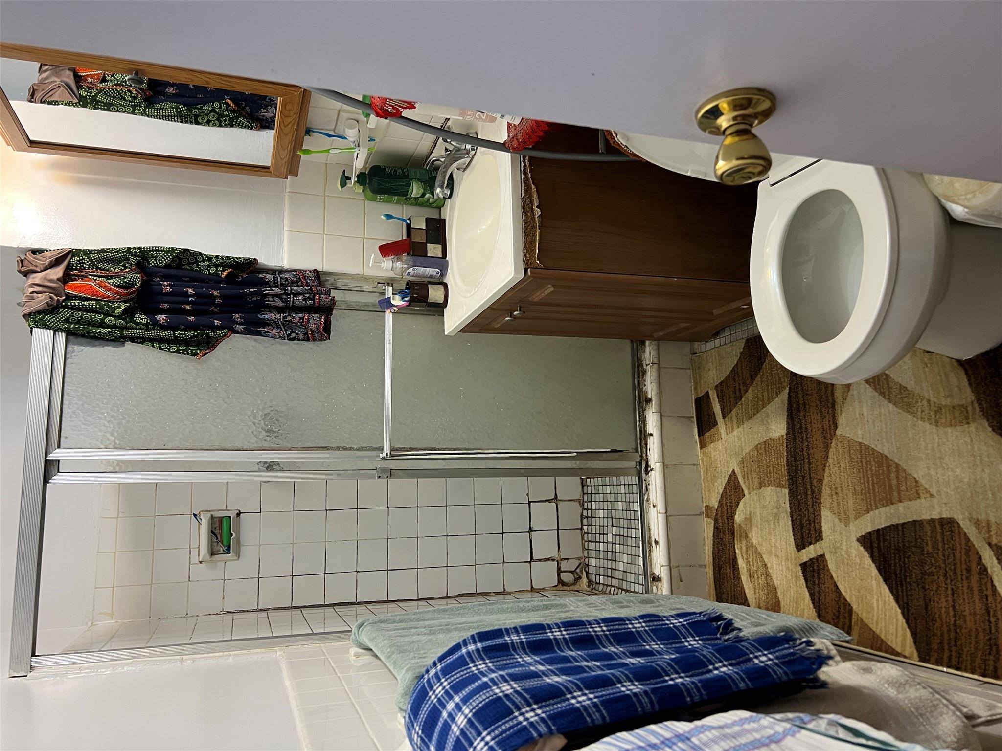 55-30 99th Street, Unit 2H Queens, NY 11368 - Photo 10 of 19 a bathroom with a sink toilet and shower