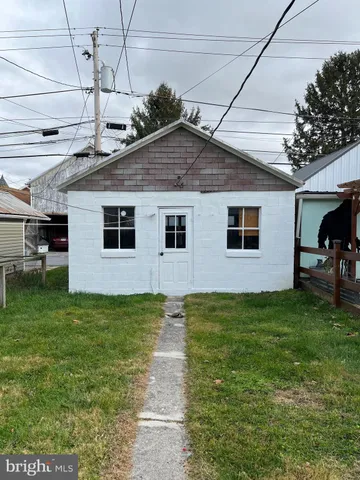 a view of a backyard with plants and a garden