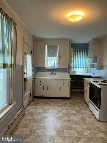 a spacious bathroom with a granite countertop sink and a large mirror