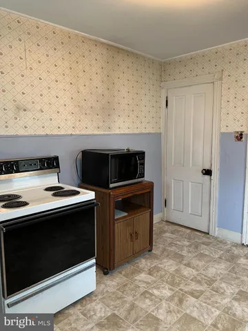 a kitchen with a stove and a microwave