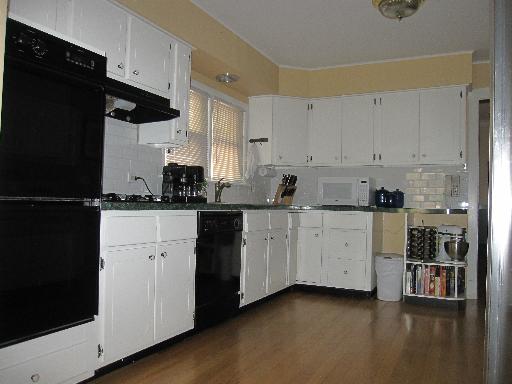 336 Olmsted Road Riverside, IL 60546 - Photo 5 of 12 a kitchen with granite countertop white cabinets and refrigerator