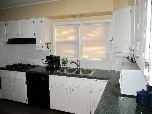 336 Olmsted Road Riverside, IL 60546 - Photo 6 of 12 a kitchen with granite countertop a sink a stove and cabinets