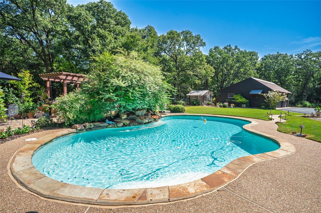 1516 Rancho Road Quinlan, TX 75474 - Photo 29 of 40 a view of a swimming pool with a yard