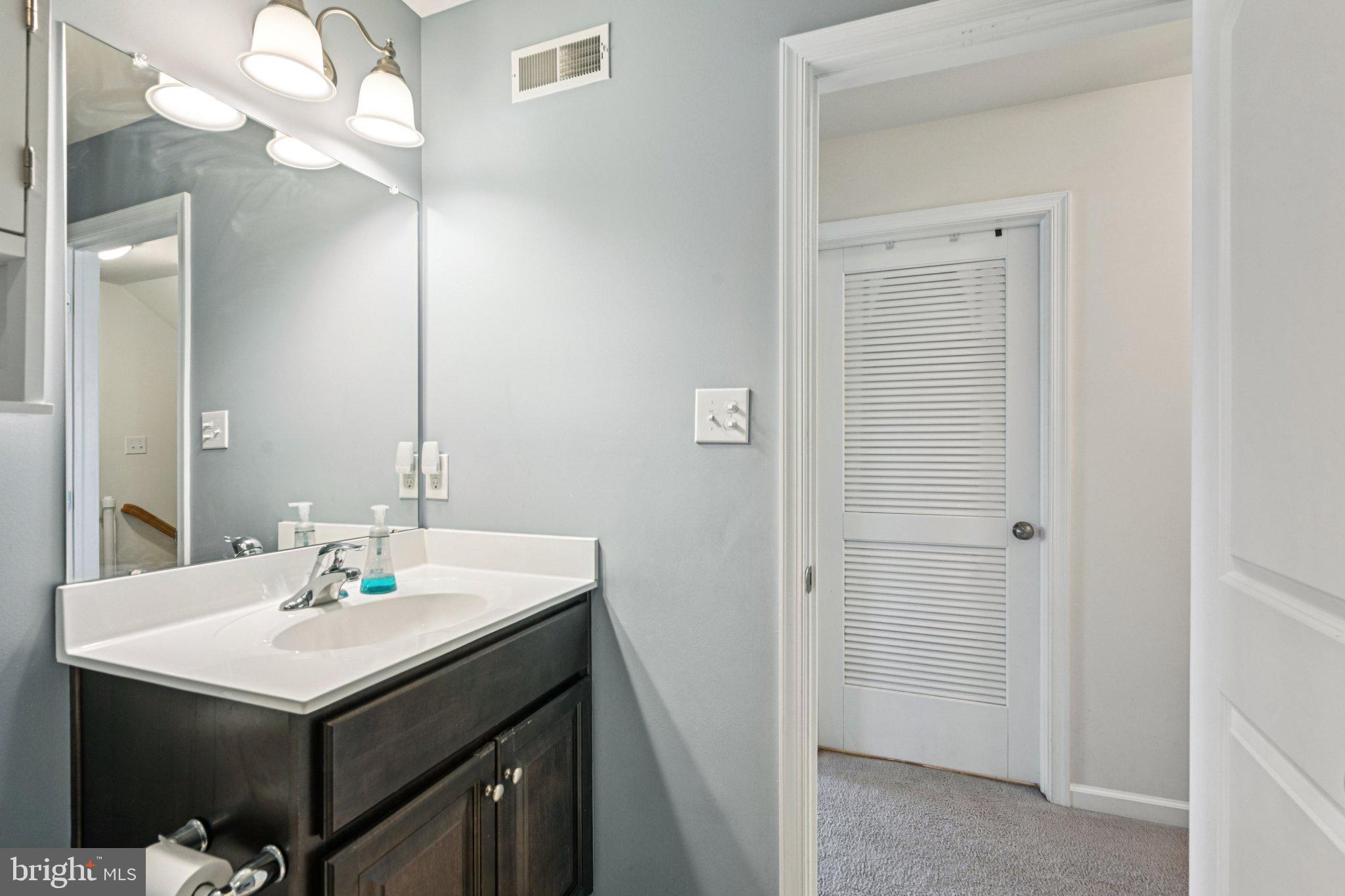 400 North York Road, Unit D Hatboro, PA 19040 - Photo 21 of 48 a bathroom with a sink a light fixture and a mirror