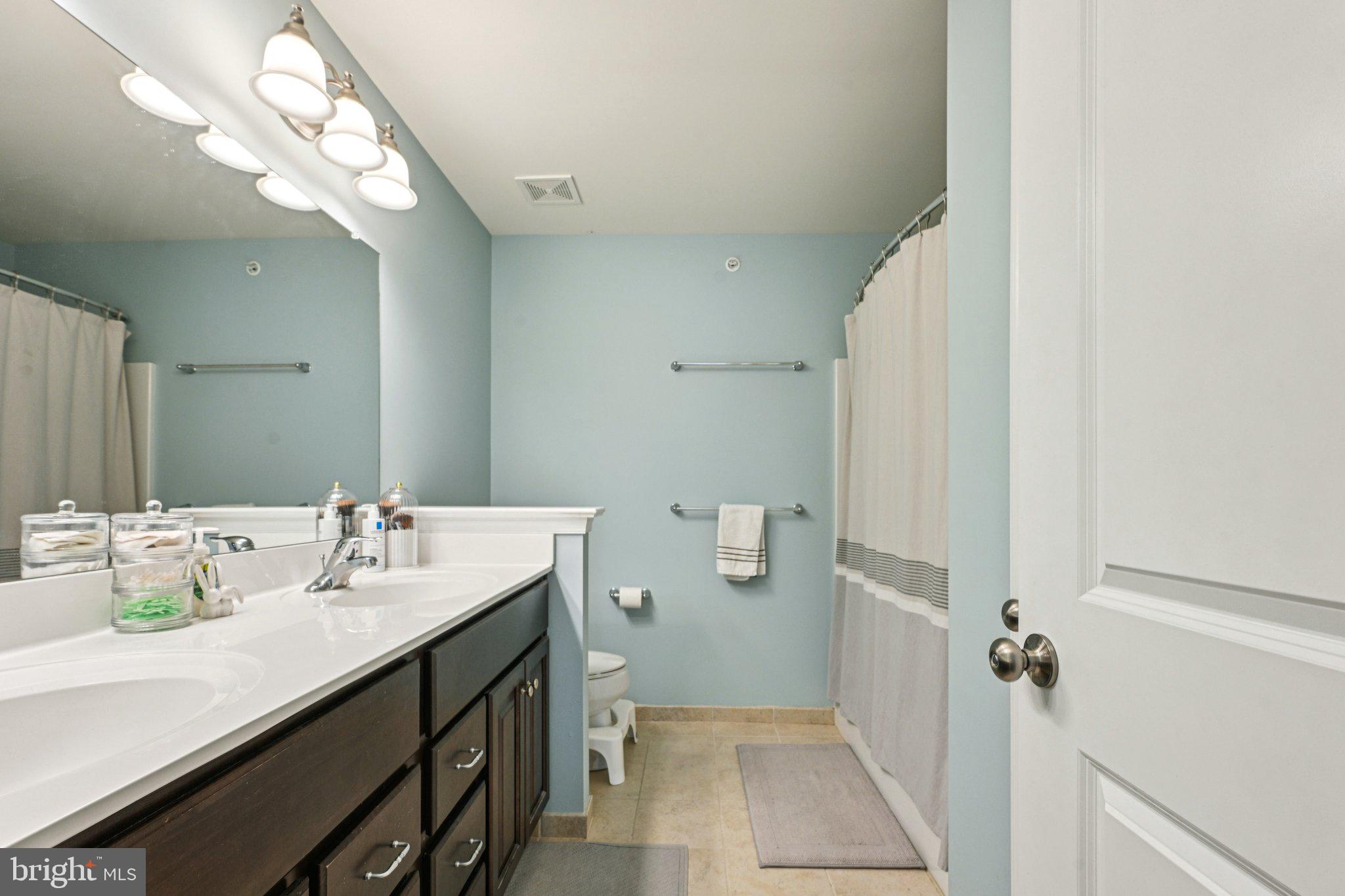 400 North York Road, Unit D Hatboro, PA 19040 - Photo 29 of 48 a bathroom with a sink a mirror and a toilet