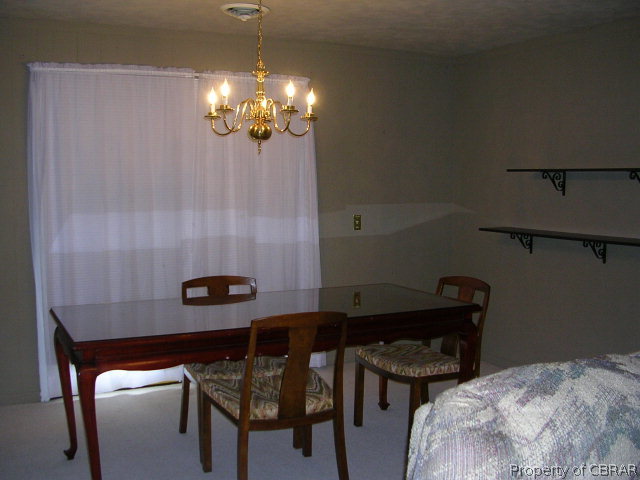 301 Beaumar Road Moon, VA 23119 - Photo 14 of 25 a dining room with furniture and chandelier