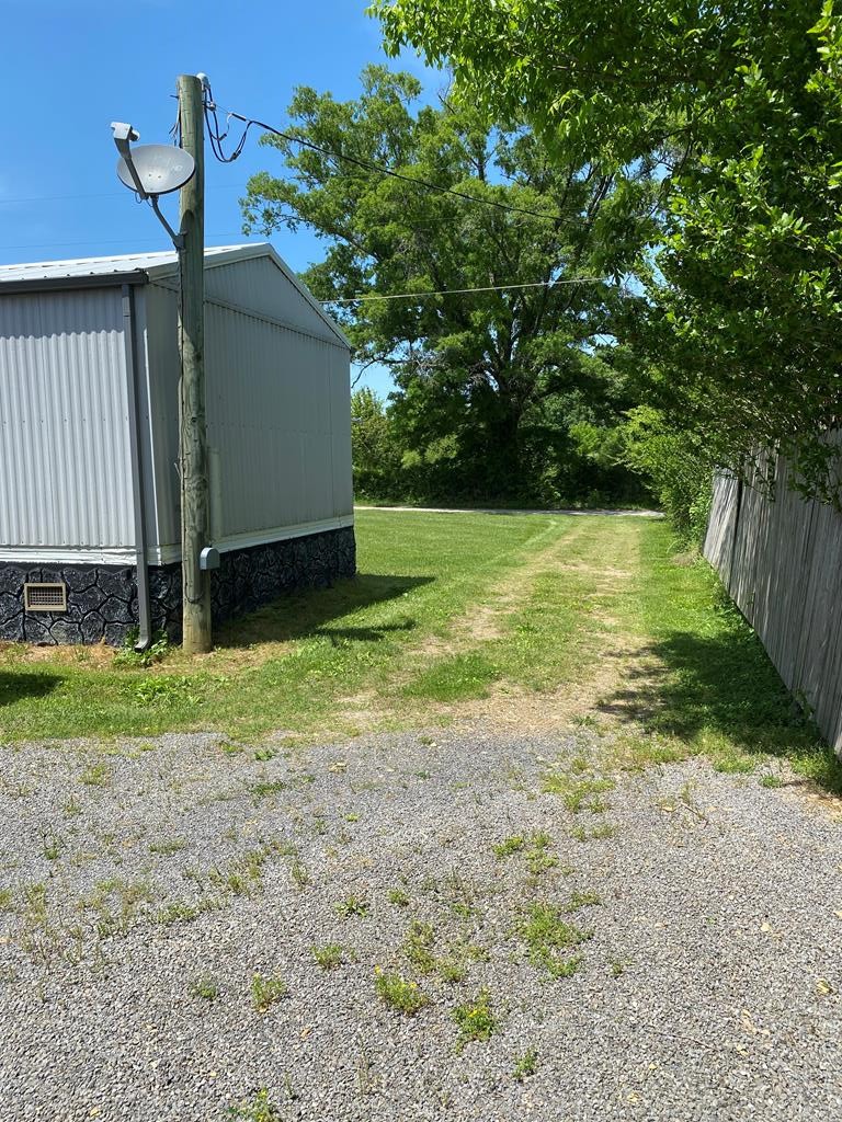 313 Lonesome Pine Road Bybee, TN 37713 - Photo 40 of 48 a backyard of a house with lots of green space