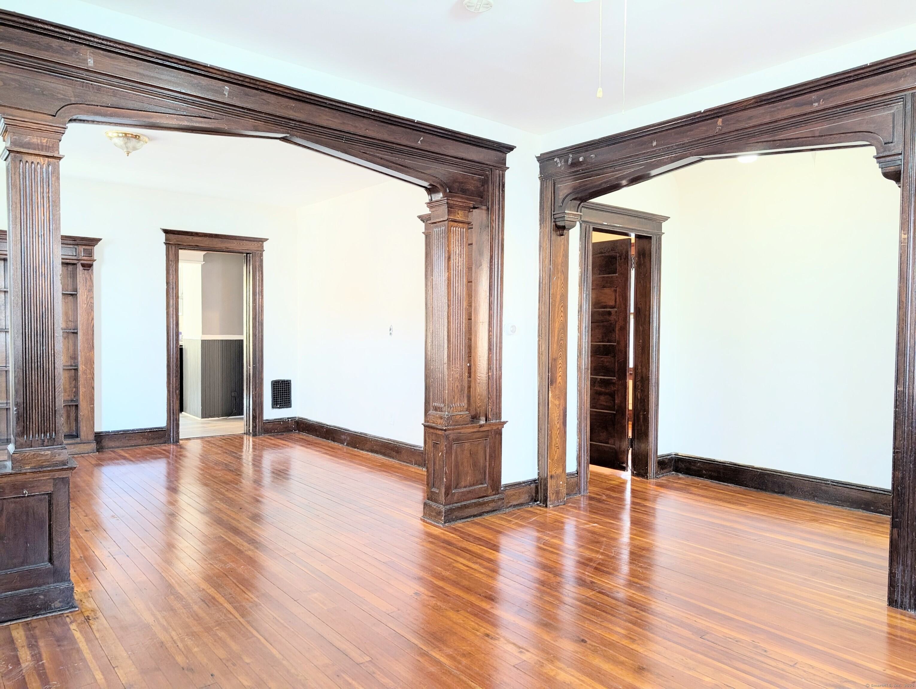 133 Poplar Street Bridgeport, CT 06605 - Photo 12 of 36 a view of a big room with wooden floor and windows