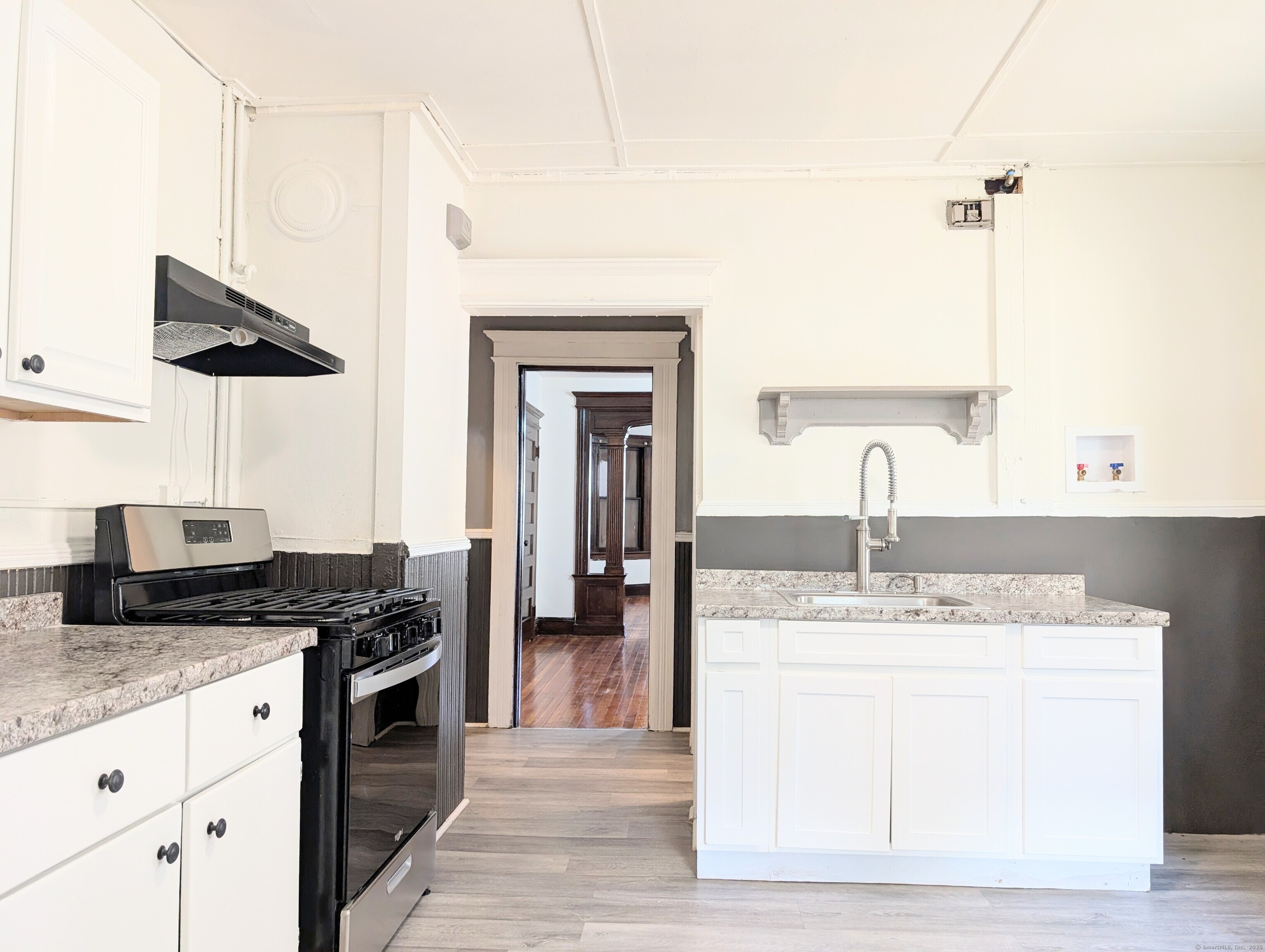 133 Poplar Street Bridgeport, CT 06605 - Photo 16 of 36 a kitchen with stainless steel appliances granite countertop a sink a stove and a wooden floors