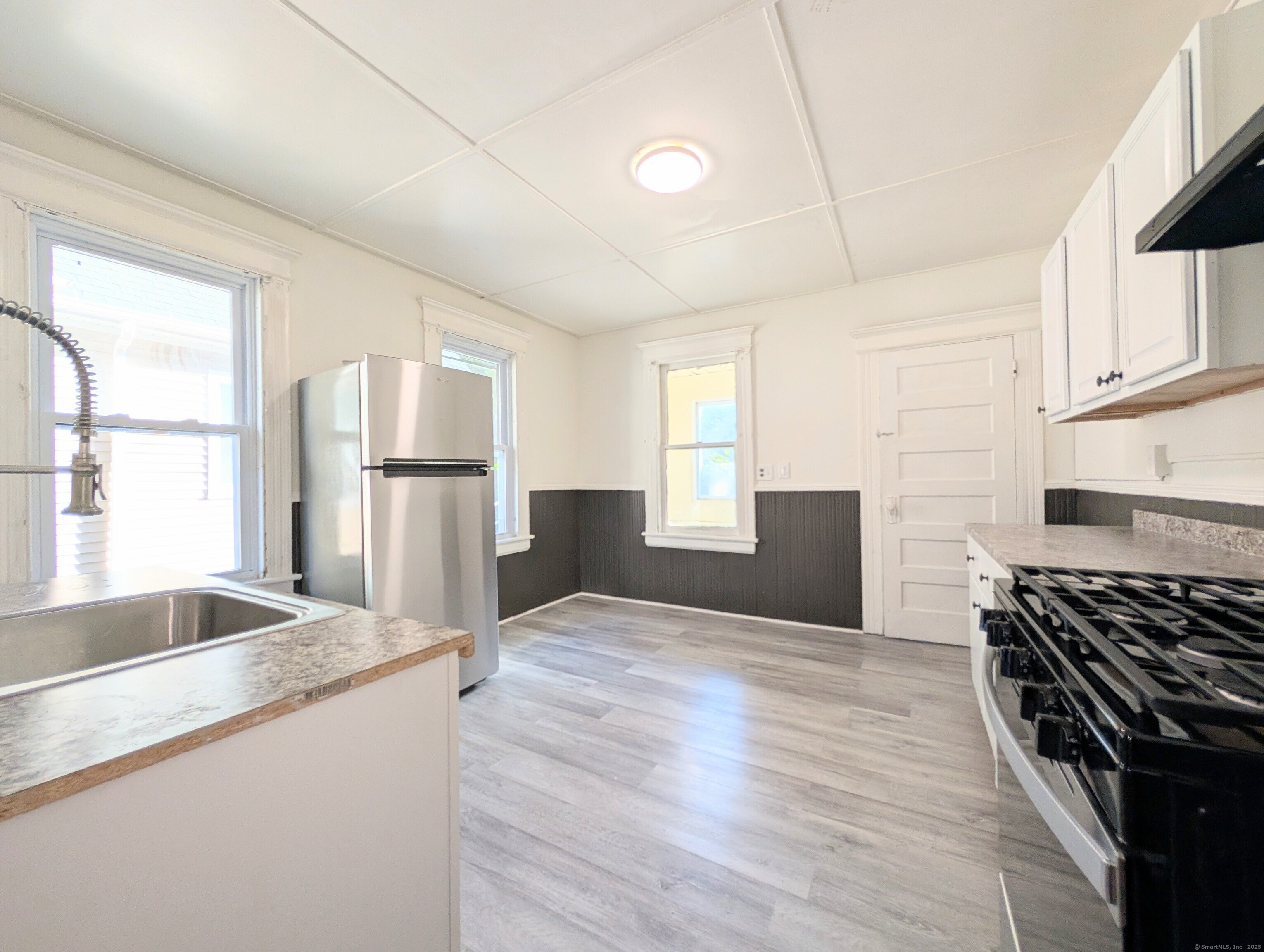 133 Poplar Street Bridgeport, CT 06605 - Photo 20 of 36 a kitchen with granite countertop a sink stove and refrigerator