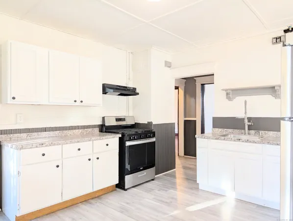 a kitchen with stainless steel appliances granite countertop a stove and a sink