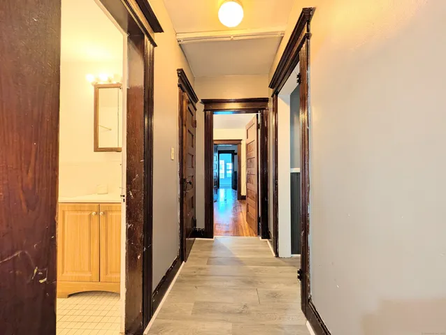 a view of a hallway with wooden floor and staircase