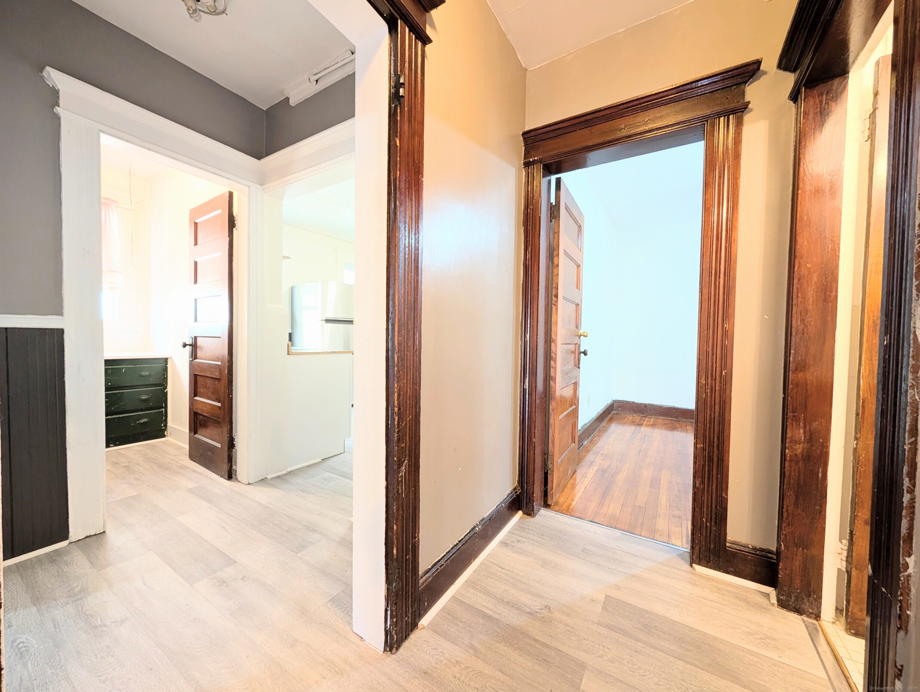 133 Poplar Street Bridgeport, CT 06605 - Photo 29 of 36 a view of a hallway with wooden floor and closet