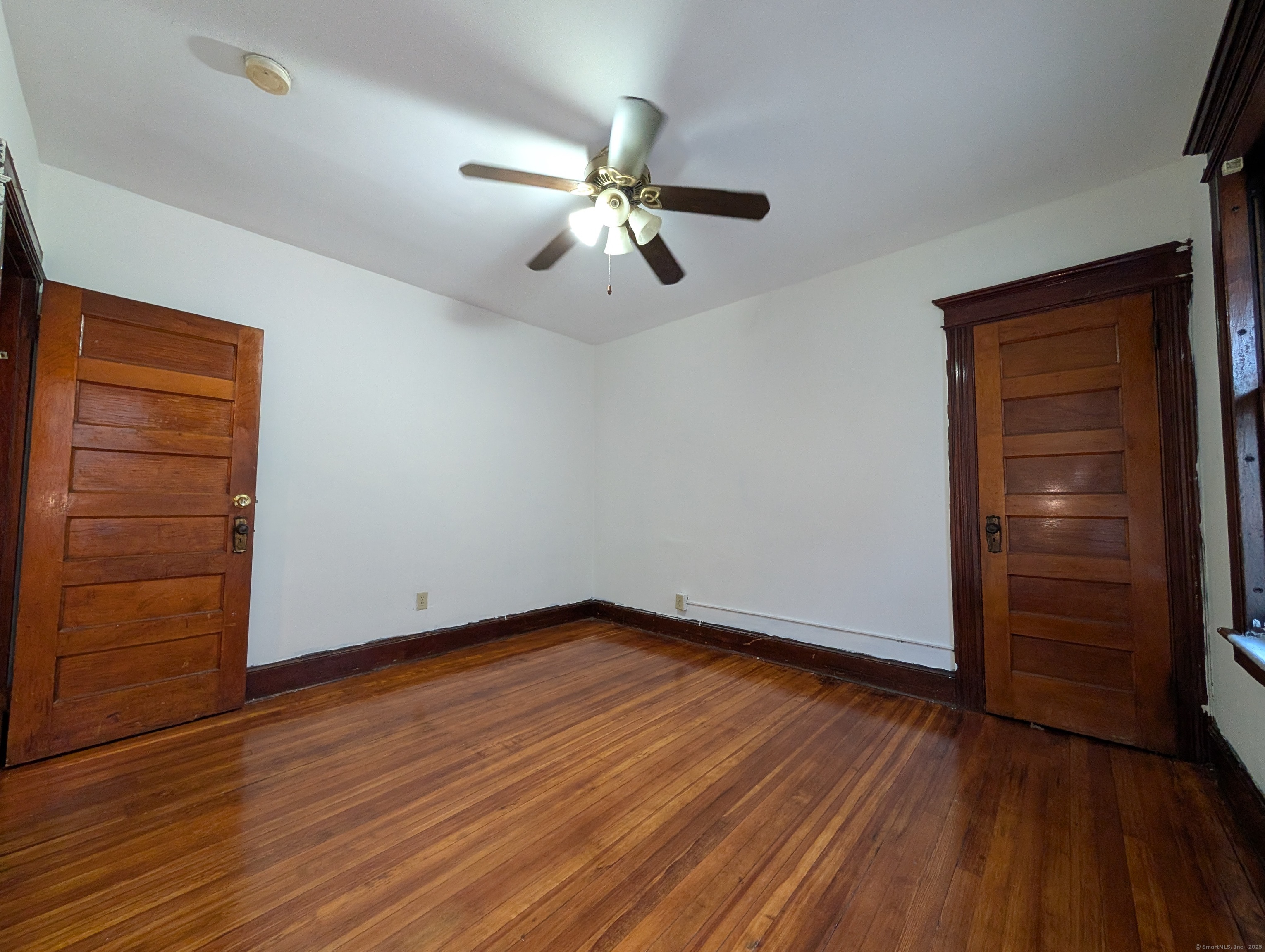 133 Poplar Street Bridgeport, CT 06605 - Photo 34 of 36 wooden floor in an empty room with a window