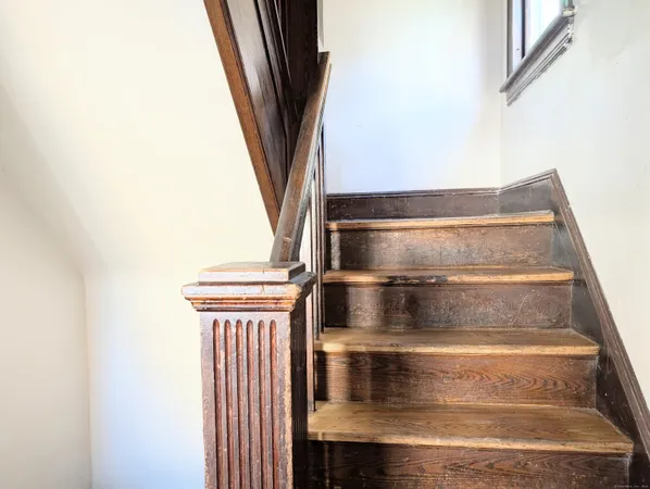a view of staircase with white walls