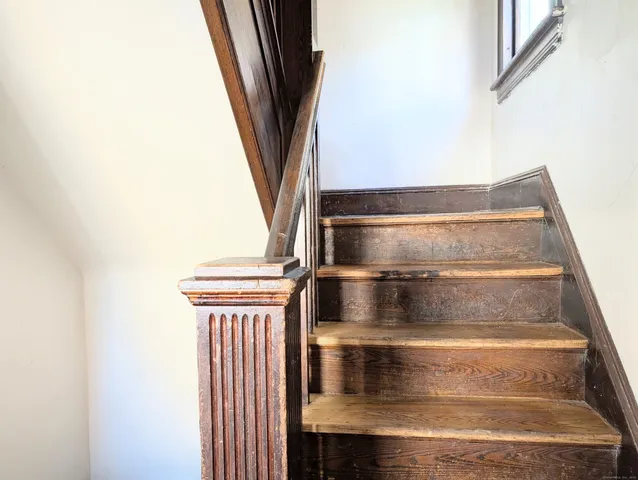 a view of staircase with white walls
