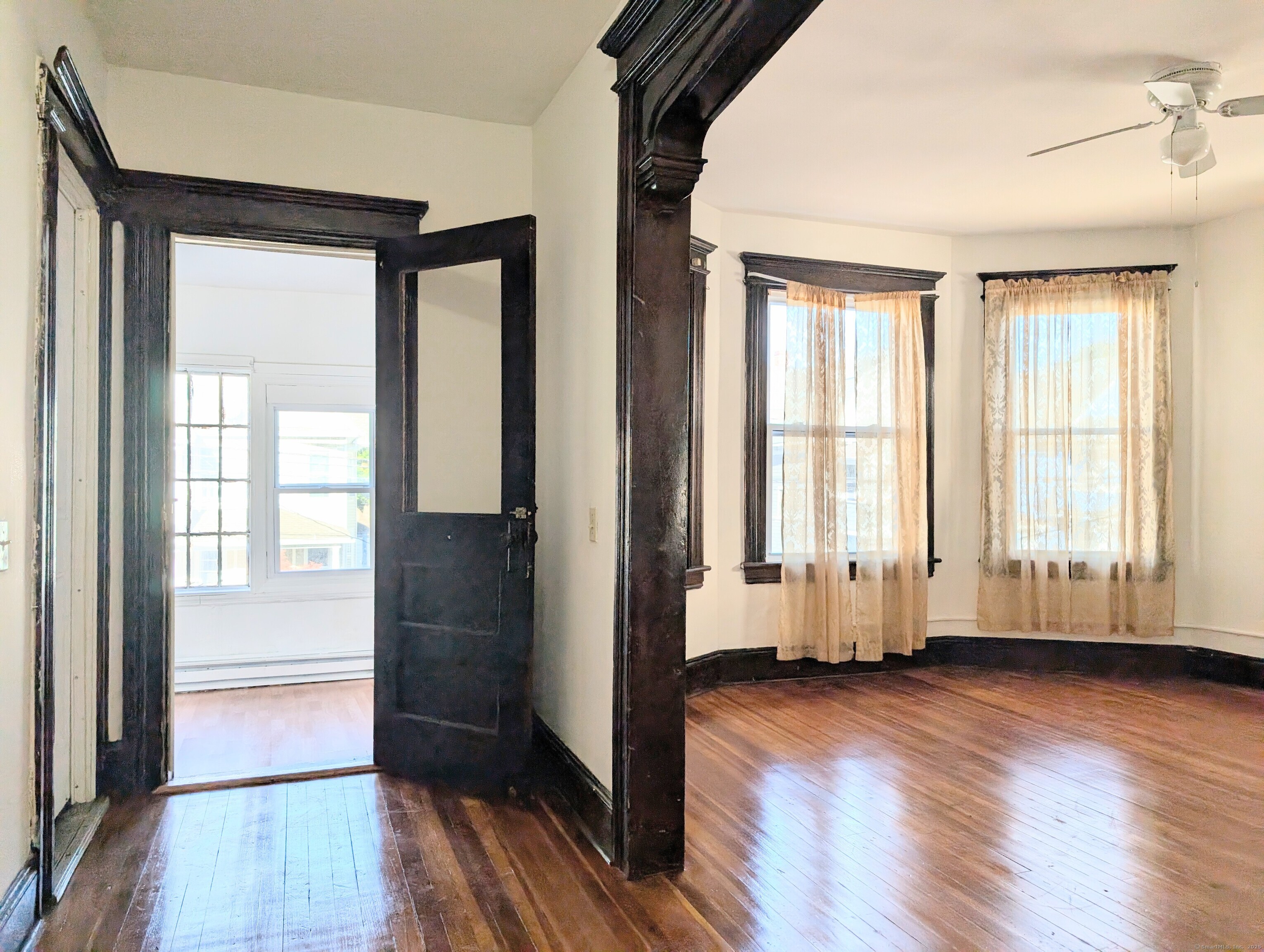 133 Poplar Street Bridgeport, CT 06605 - Photo 6 of 36 an empty room with wooden floor and windows