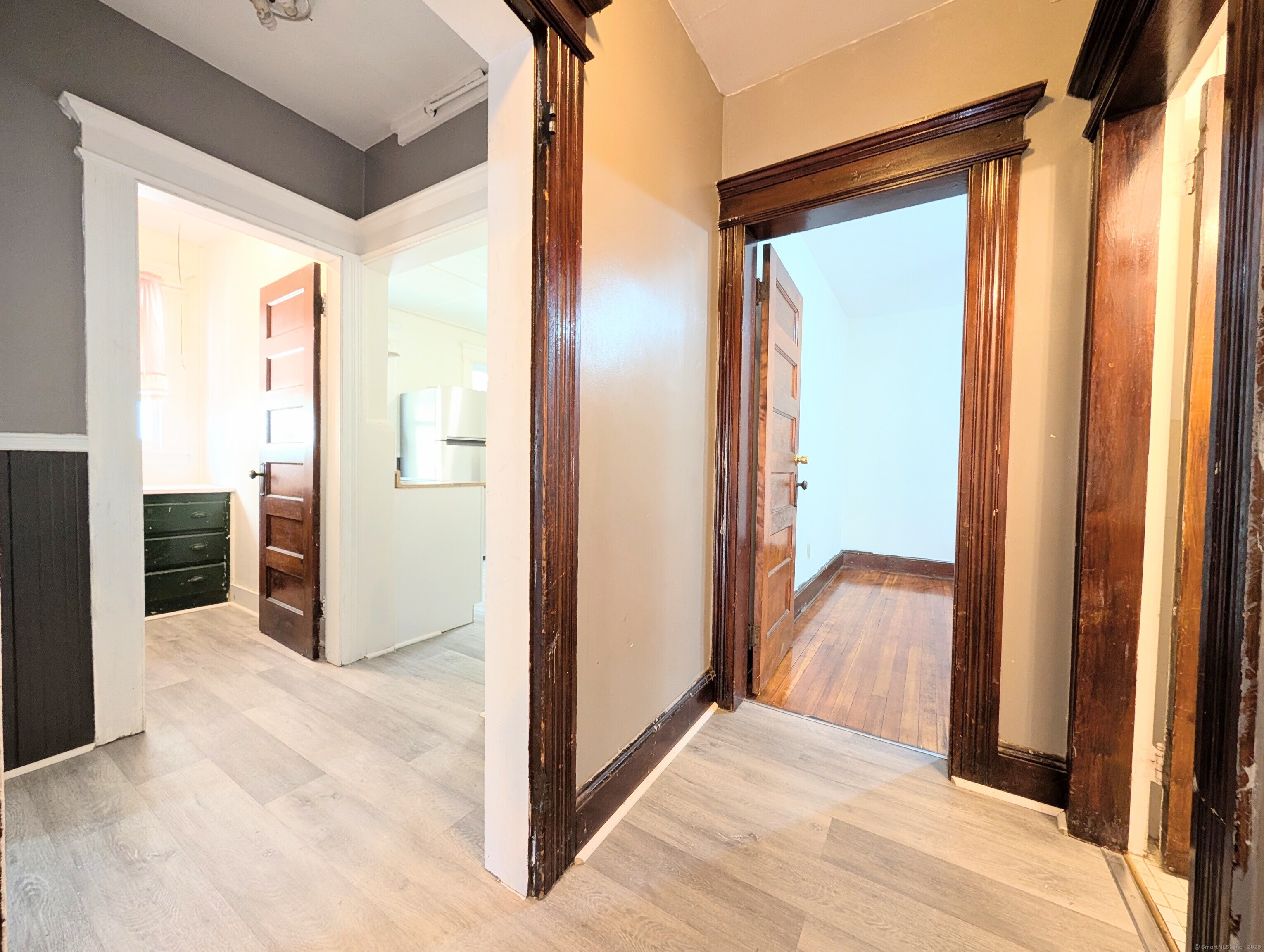133 Poplar Street Bridgeport, CT 06605 - Photo 7 of 36 a view of a hallway with wooden floor and closet