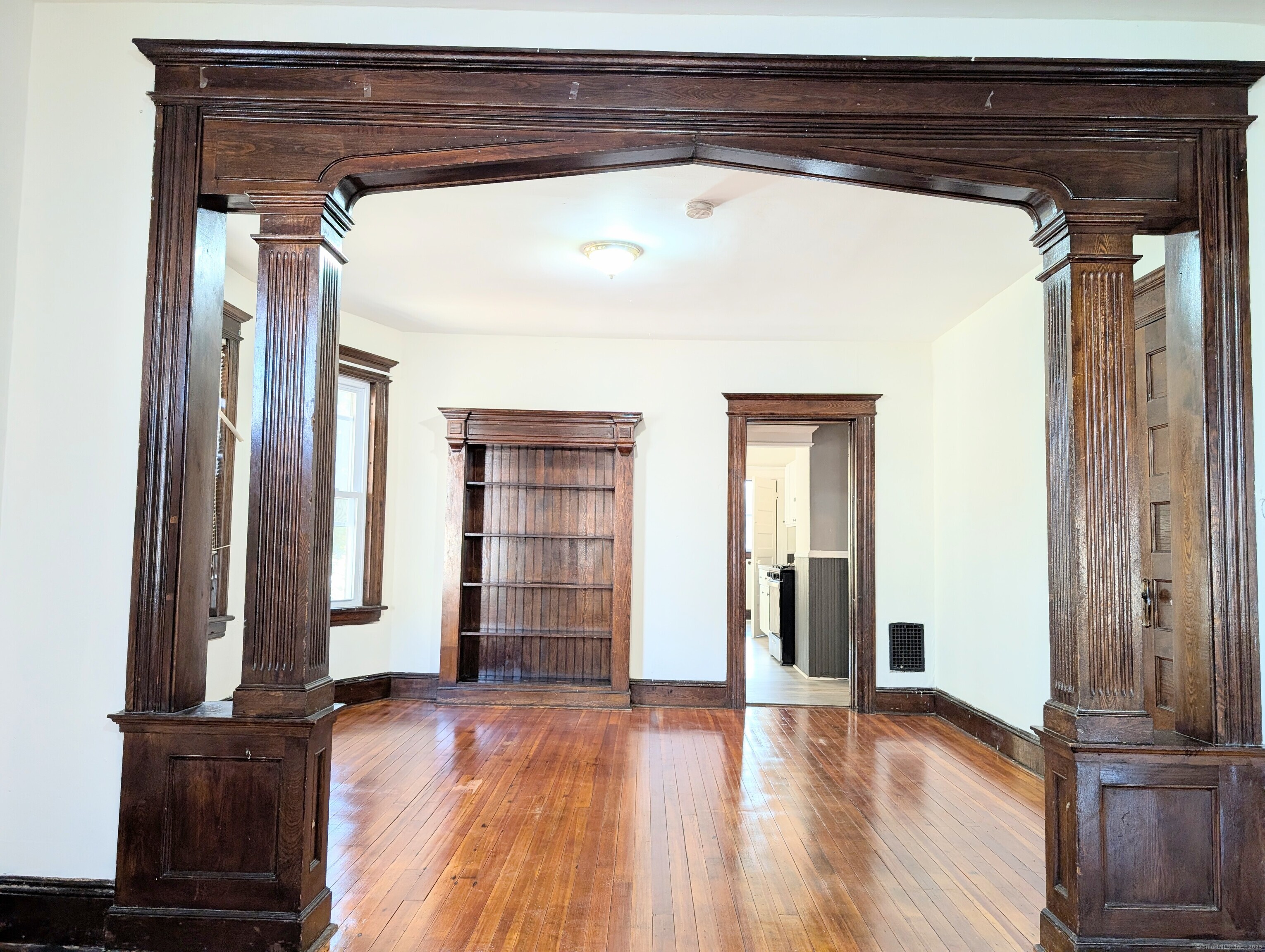 133 Poplar Street Bridgeport, CT 06605 - Photo 10 of 36 a view of empty room with wooden floor and wall