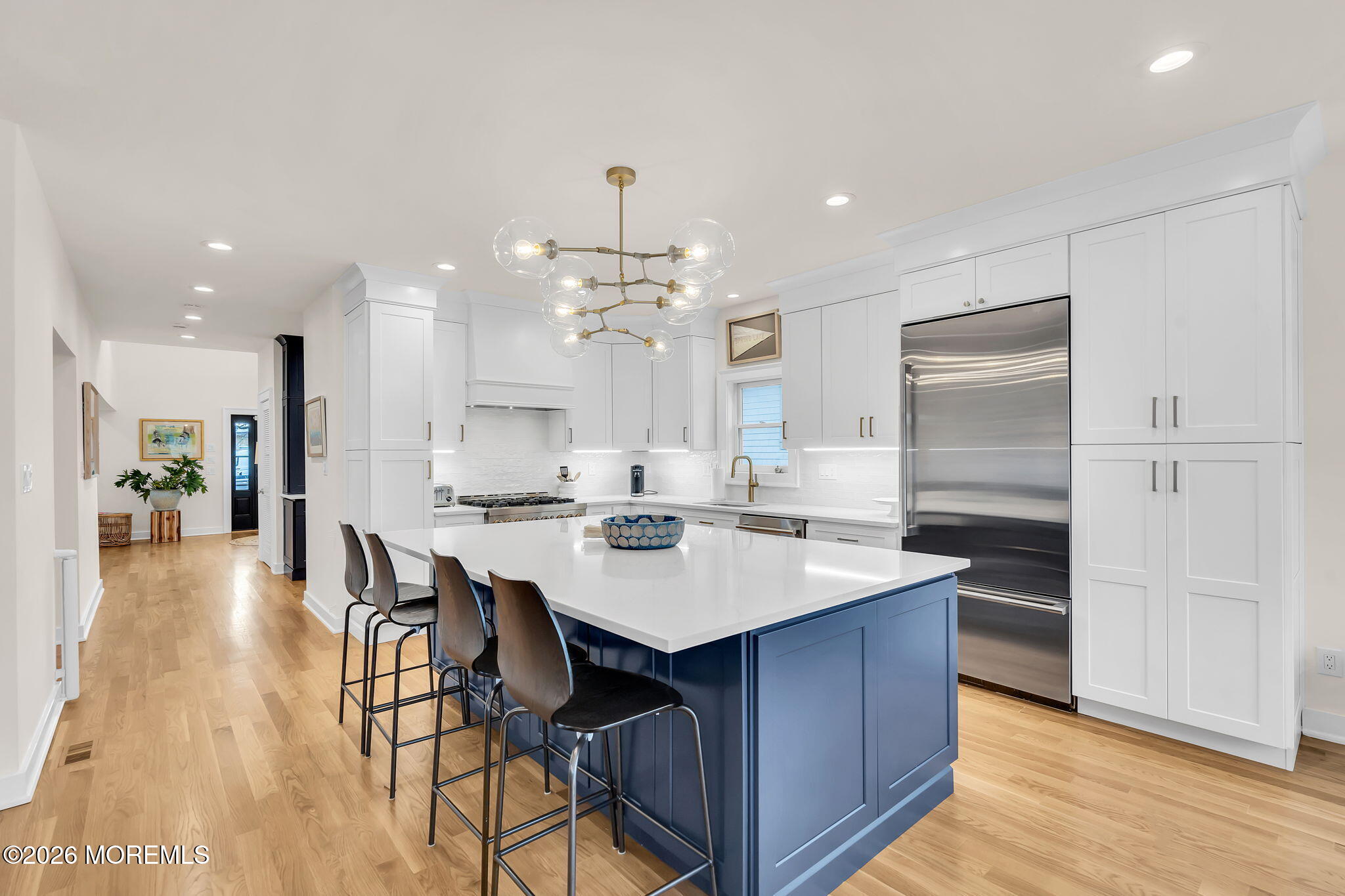 208 Salem Avenue Spring Lake, NJ 07762 - Photo 29 of 102 a large kitchen with kitchen island a dining table chairs and a wooden floor