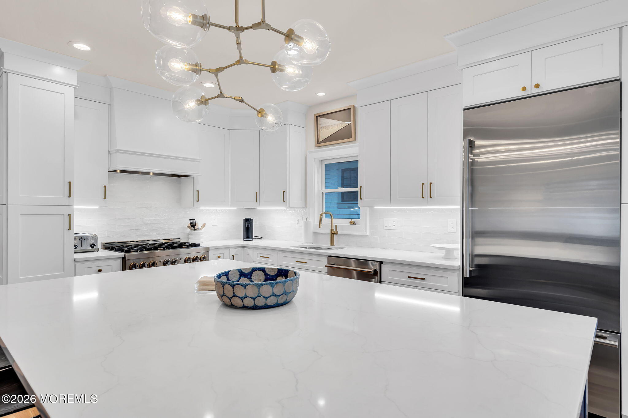 208 Salem Avenue Spring Lake, NJ 07762 - Photo 30 of 102 a kitchen with kitchen island a stove a sink and a refrigerator