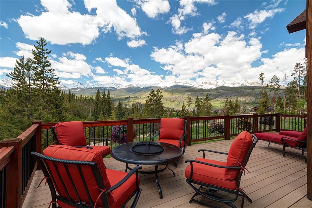22 Braddock Drive Breckenridge, CO 80424 - Photo 2 of 35 a roof deck with a table and chairs with wooden floor