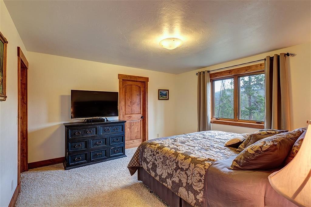 22 Braddock Drive Breckenridge, CO 80424 - Photo 15 of 35 a bedroom with a bed and a television in it