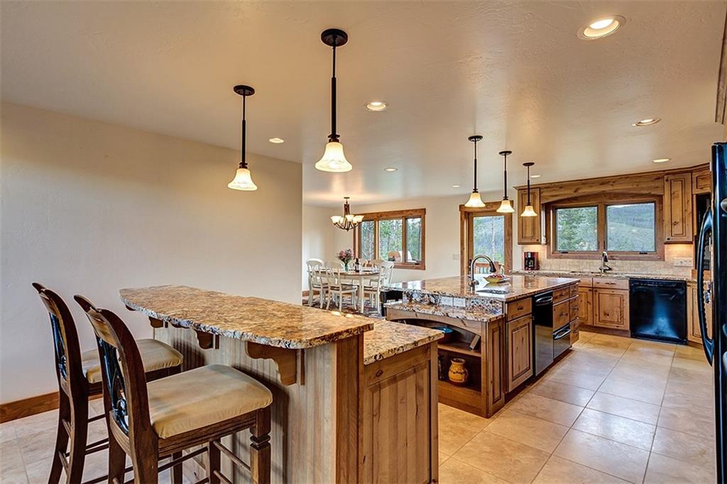 22 Braddock Drive Breckenridge, CO 80424 - Photo 18 of 35 a kitchen with a stove a sink a dining table and chairs