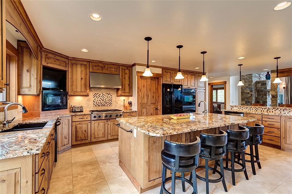 22 Braddock Drive Breckenridge, CO 80424 - Photo 3 of 35 a kitchen with stainless steel appliances kitchen island granite countertop a sink and cabinets
