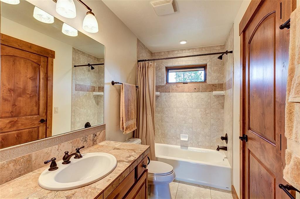 22 Braddock Drive Breckenridge, CO 80424 - Photo 25 of 35 a bathroom with a sink double vanity mirror and a bathtub