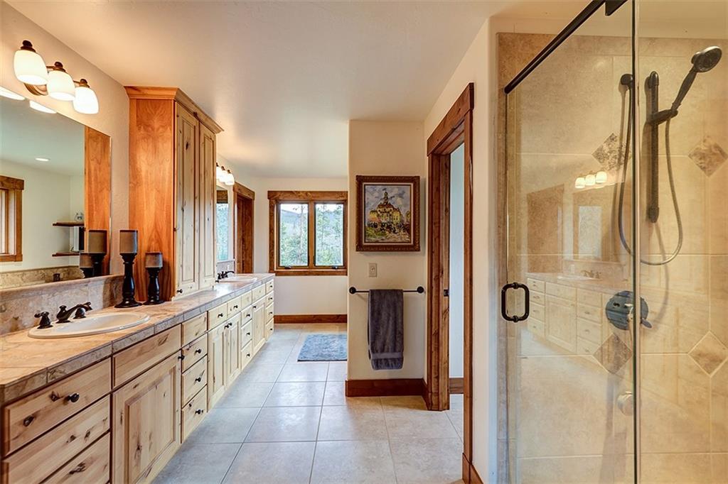 22 Braddock Drive Breckenridge, CO 80424 - Photo 5 of 35 a large bathroom with a double vanity sink and mirror with shower