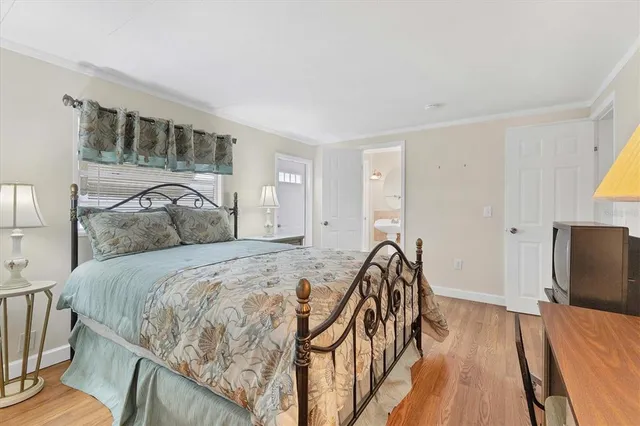 a bed sitting in a spacious bedroom next to a window