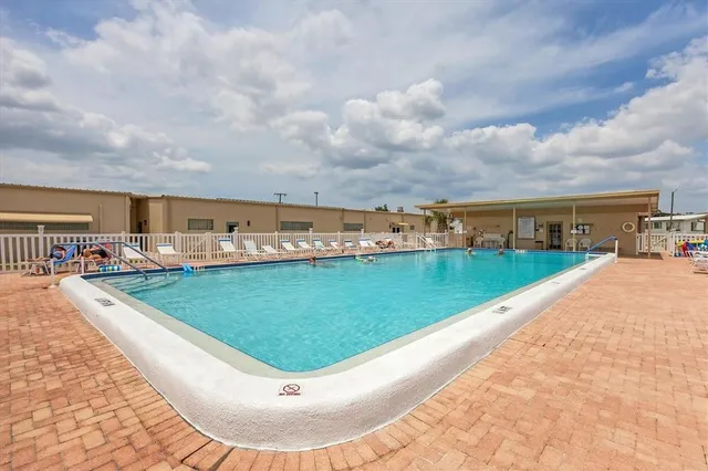 a view of a swimming pool with an outdoor seating