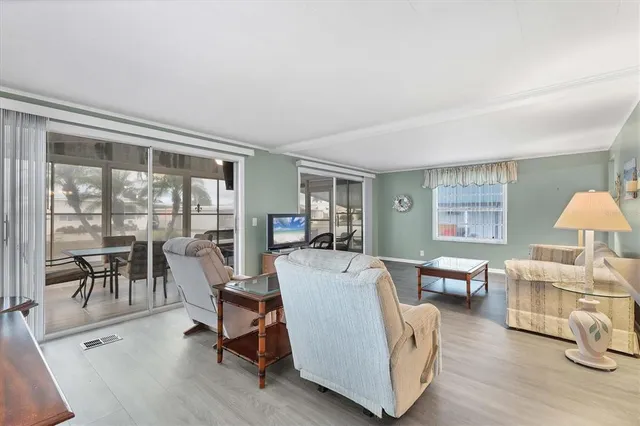 a living room with furniture a table and a large window