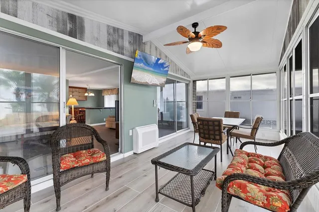 a bedroom with furniture and a large window